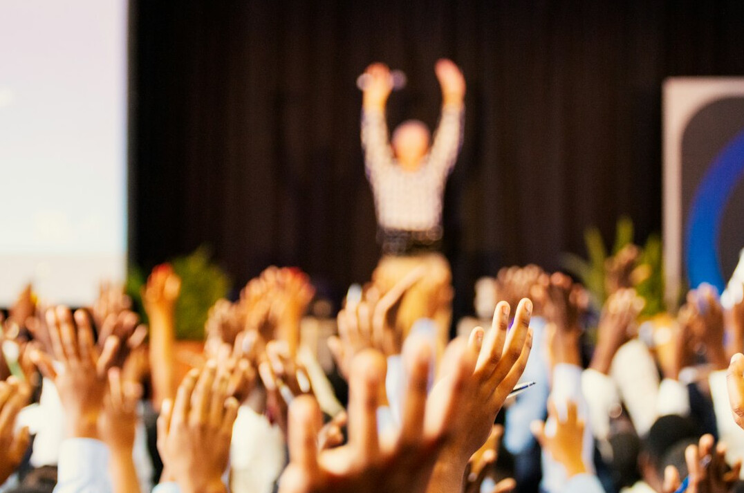 person giving speech on stage